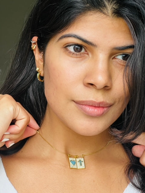 Close-up of a gold-plated Christian necklace with a radiant cubic zirconia cross pendant