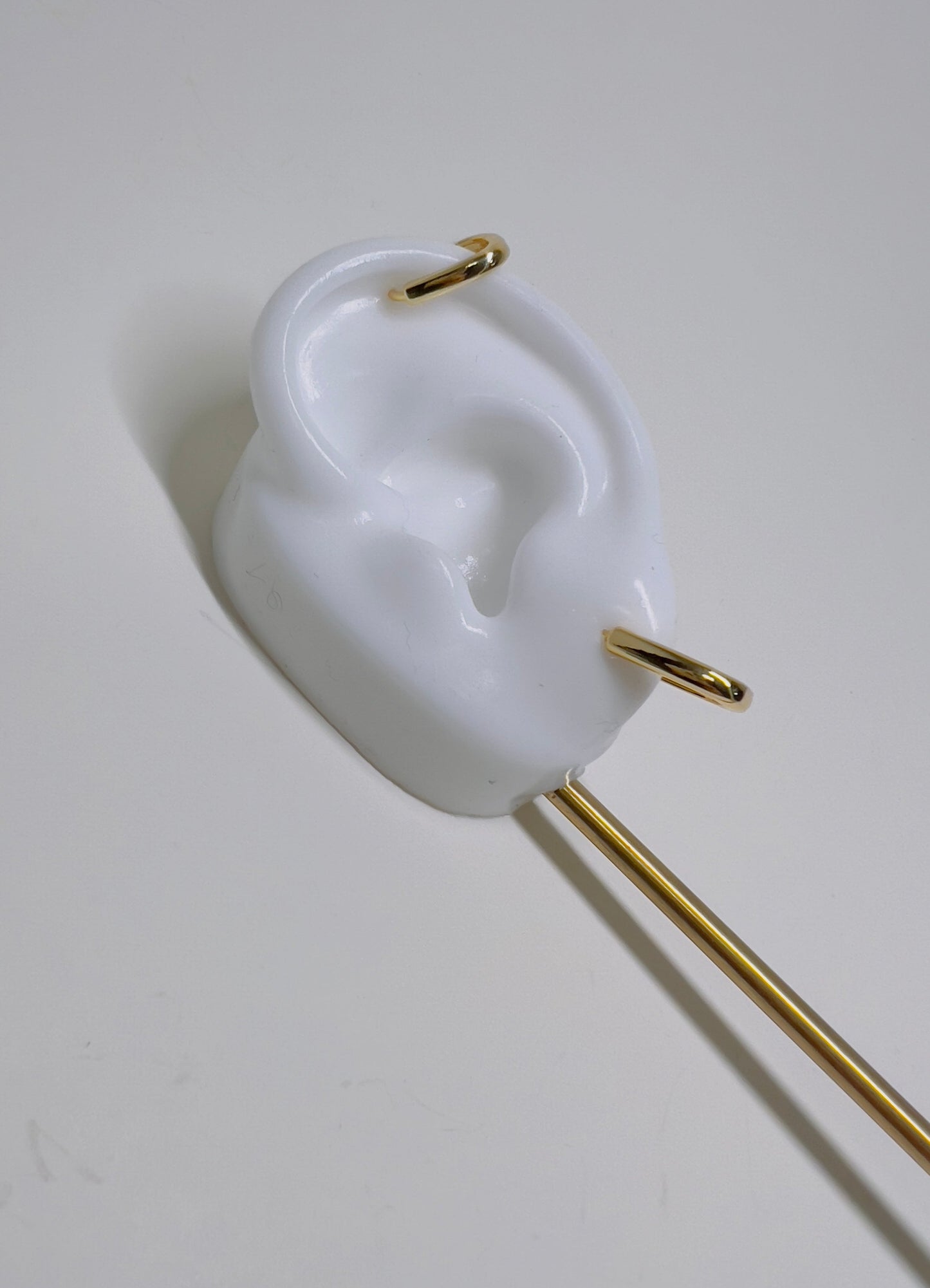 white silicon ear with gold squared huggies