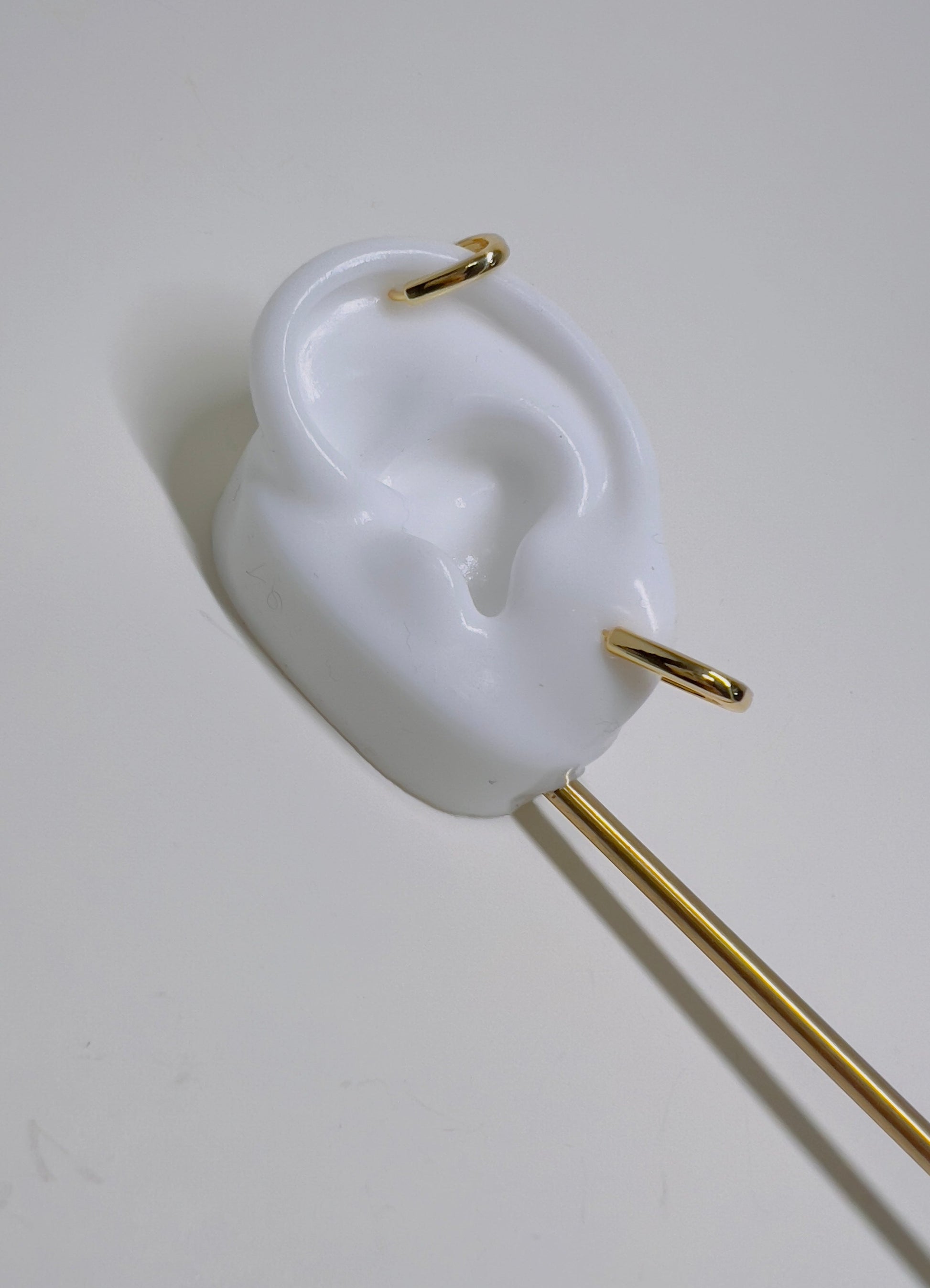 white silicon ear with gold squared huggies