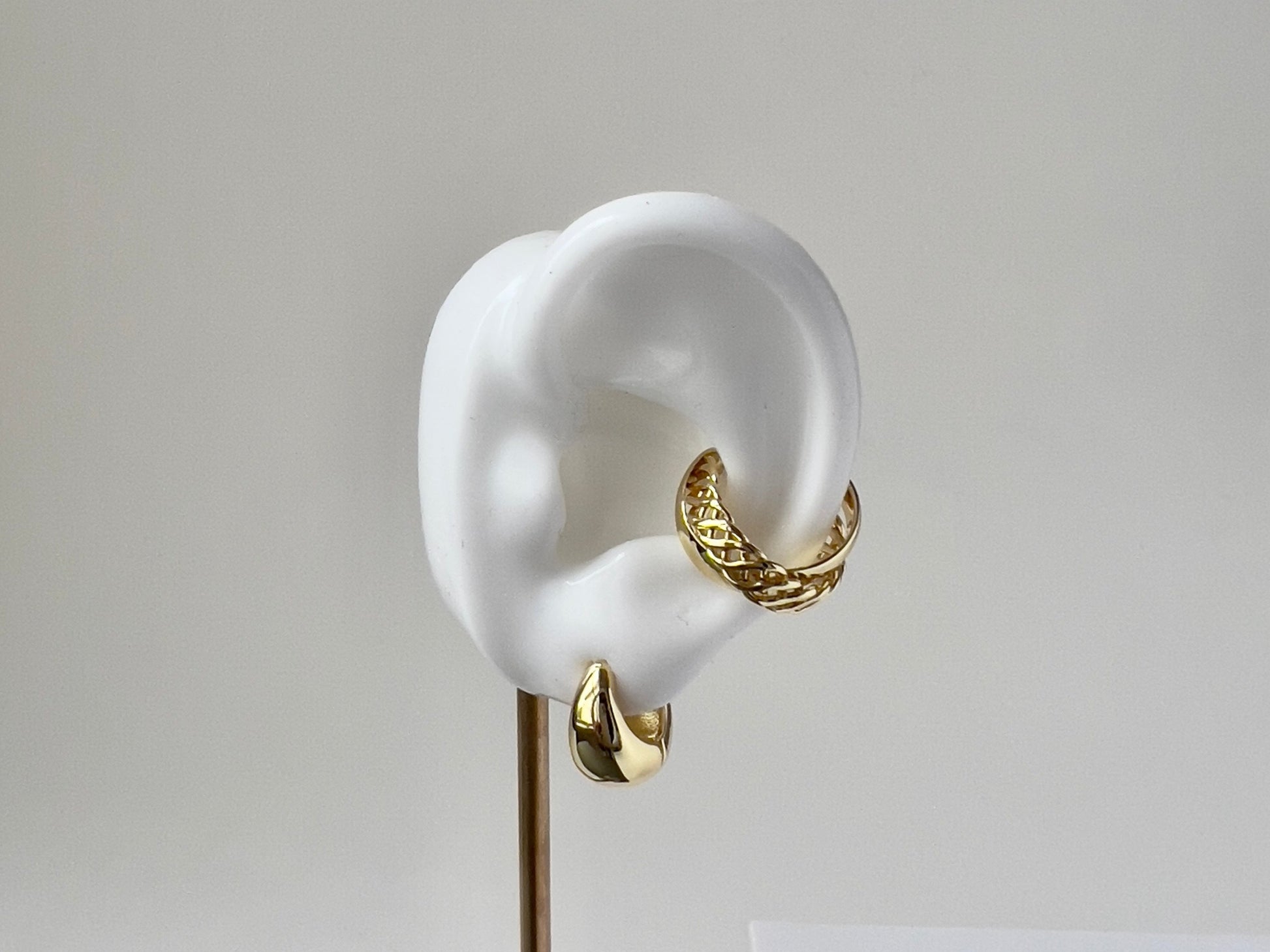 classic gold huggie hoop earring on silicon ear to display