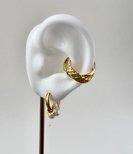 gold hoop earring with dangling faux pearls in a white silicon ear