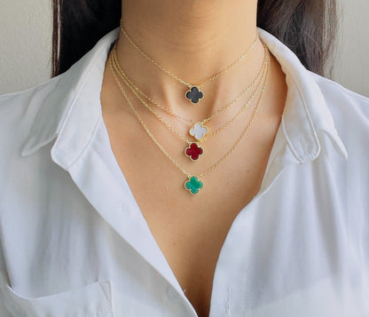 All four leaf clover necklaces in red, black, white and green on a women