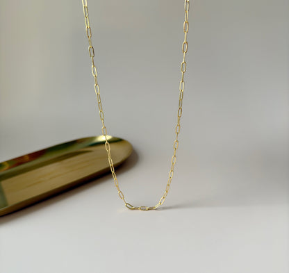 Gold paperclip necklace with modern, interlocking links, highlighting its simplicity and elegance.