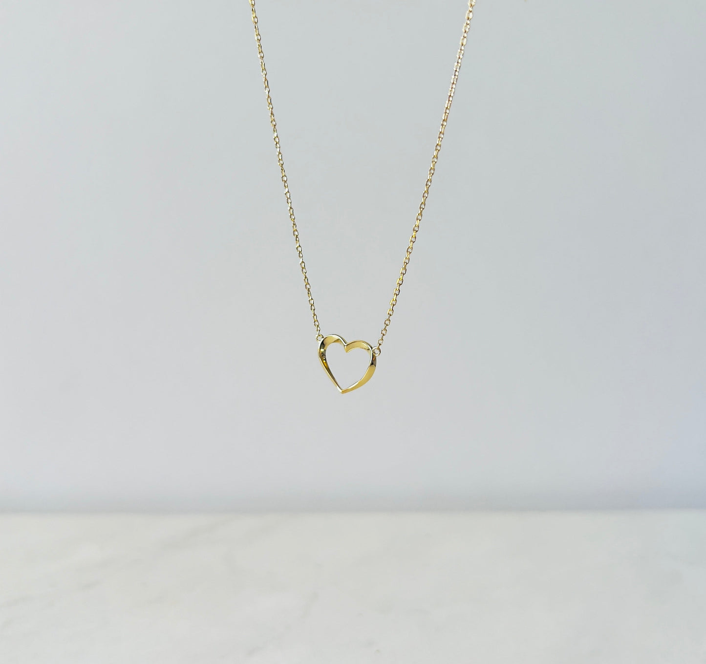 wire heart pendant necklace in gold