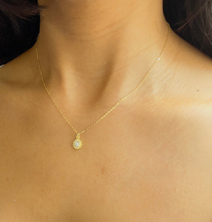 sun necklace in gold in a woman