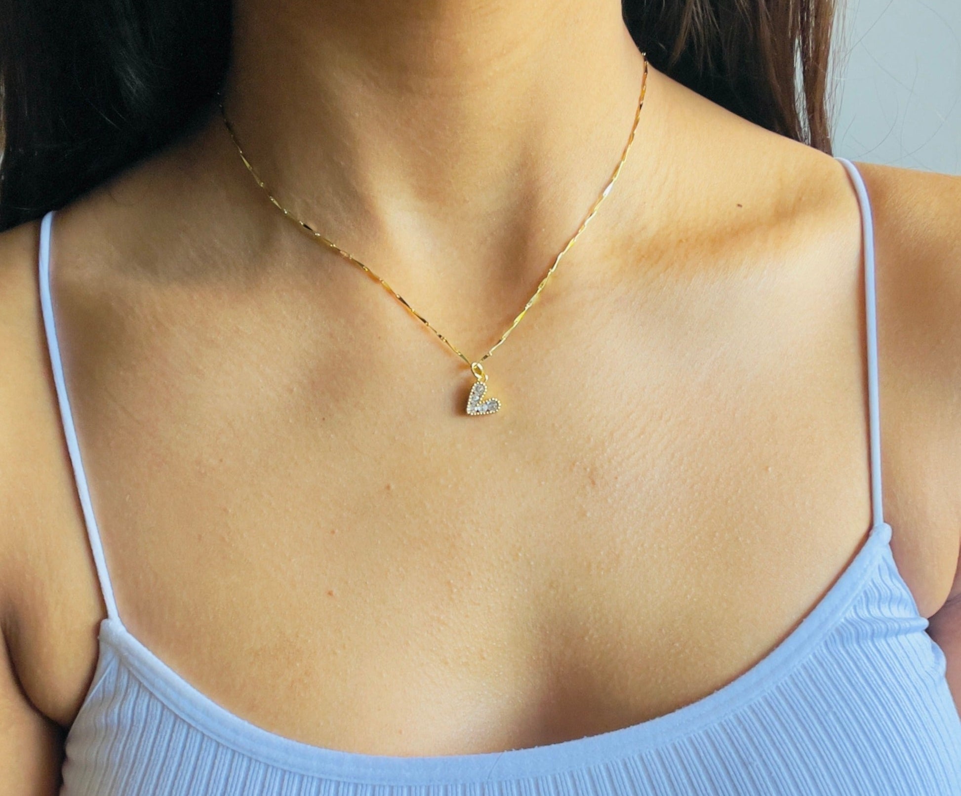 heart necklace in a woman's neck