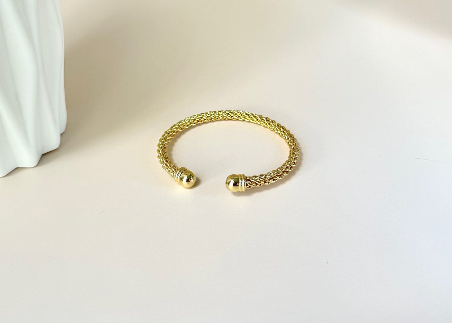 Classic Royal Wrist Bangle laying on a flat surface