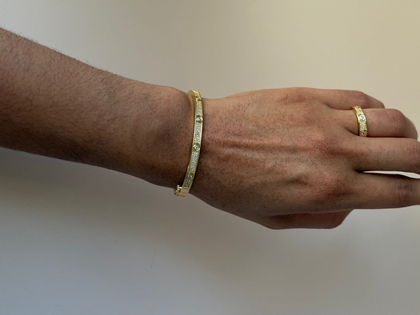  bangle and ring close-up – a delicate bangle and ring adorned with intricate zirconia clover details, crafted to bring sparkle and good fortune to any look