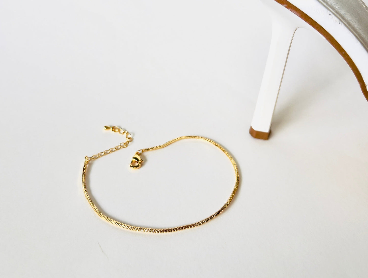 Sleek snake chain gold anklet with secure lobster clasp - Stylish and versatile ankle accessory