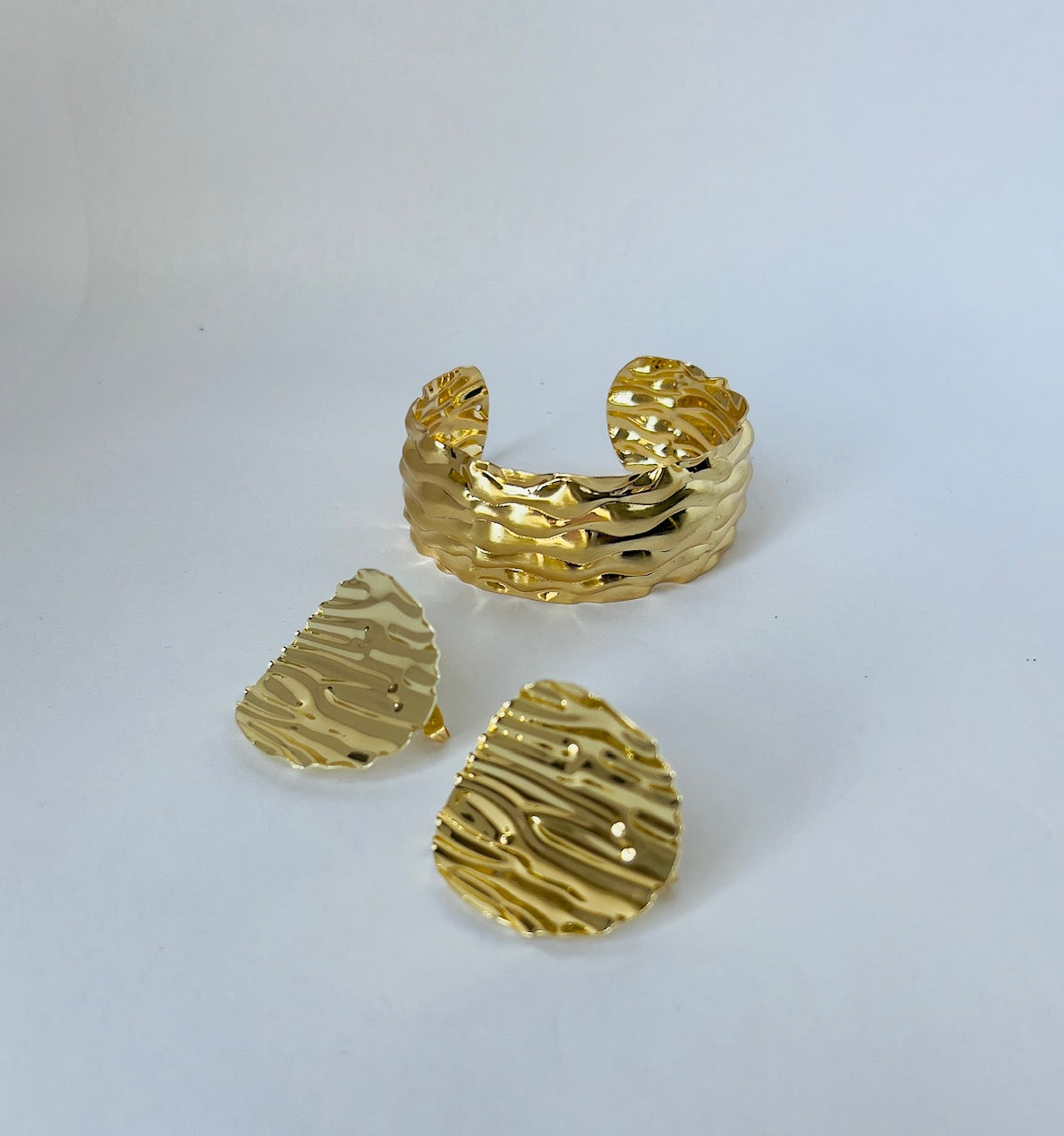 Elevate your style: Large gold plated earrings set with a chic corrugated texture. Perfect for women who love bold accessories.